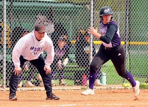 Vincent Massey Vikings AAAA varsity girls' fast pitch coach Braden Pillings looks on as his Grade 9 catcher Kaylee Rank heads for home for the first of her two homers Monday afternoon at the Ashley Neufeld Softball Complex. Rank and her teammates mercied the Neelin Spartans AAA varsity girls' team 11-3 after five innings. (Jules Xavier/The Brandon Sun)