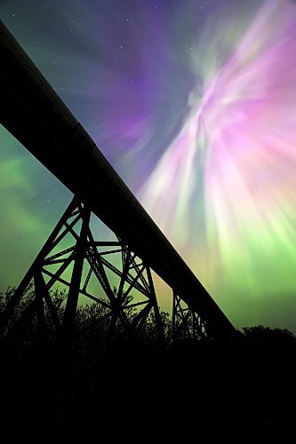 An explosion of colour from the aurora borealis fills the night sky over the railway trestle at Rivers, MB early Sunday morning. A severe geomagnetic storm — the strongest the earth has seen in 20 years — caused northern lights to be seen across the northern hemisphere this past weekend, as a result of several solar flares exploding off the Sun. (Matt Goerzen/The Brandon Sun)