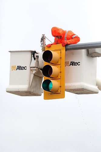 Kevin Pich, a traffic signals technician with Manitoba Transportation and Infrastructure, inspects a traffic signal at the intersection of First Street and Kirkcaldy Drive on a cool and rainy Tuesday afternoon. The provincial highways team will be in Brandon inspecting traffic signals on provincial roads this week. (Matt Goerzen/The Brandon Sun)