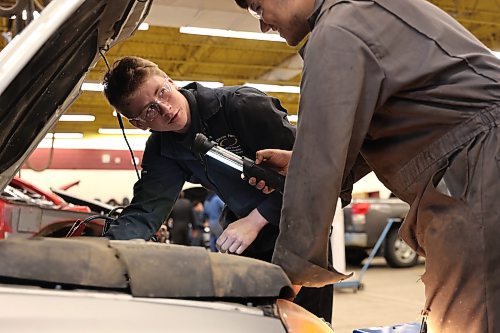 Ollie Sawatsky, Grade 12 student, discusses how he's diagnosing a compact car with a fellow student in automotive technology program at Crocus Plains Regional Secondary School on Wednesday. (Michele McDougall/The Brandon Sun)