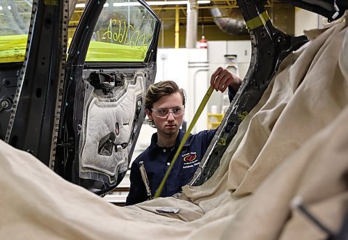 Mathew Kuszak, Grade 12 automotive technology student at Crocus Plains Regional Secondary School measures the frame of a vehicle. He is on Team Manitoba and will compete at the Skills Canada competition in Quebec at the end of the month. (Michele McDougall/The Brandon Sun) 