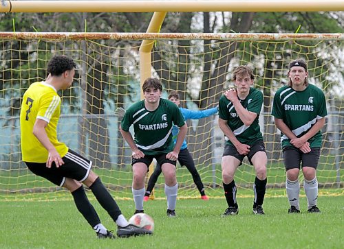 Christian Martin-Murray, left, takes a free kick for the Plainsmen against a three-man Spartans wall. (Thomas Friesen/The Brandon Sun)