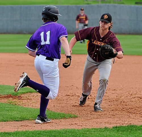 Crocus Plainsmen first baseman Will Galatiuk moves towards Vincent Massey Vikings third basemen Cason Burton for a first inning out. (Jules Xavier/The Brandon Sun)