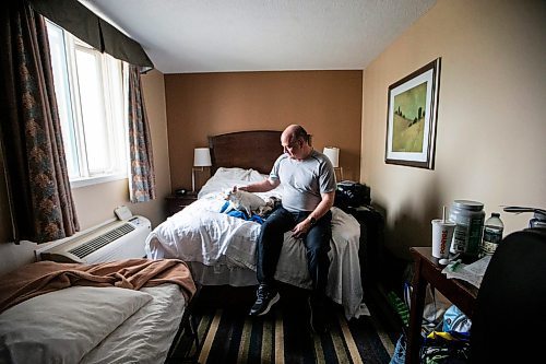 MIKAELA MACKENZIE / FREE PRESS

Des Kappel, displaced resident from Birchwood Terrace, with his dog Nemo in the hotel room they are currently staying in on Wednesday, May 15, 2024. 

For Tyler story.

