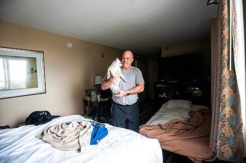 MIKAELA MACKENZIE / FREE PRESS

Des Kappel, displaced resident from Birchwood Terrace, with his dog Nemo in the hotel room they are currently staying in on Wednesday, May 15, 2024. 

For Tyler story.

