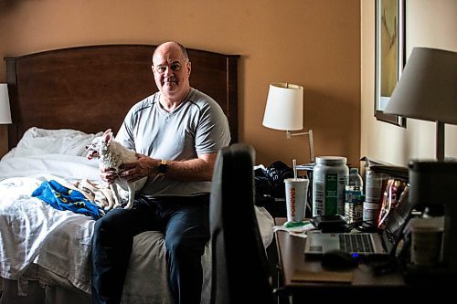 MIKAELA MACKENZIE / FREE PRESS

Des Kappel, displaced resident from Birchwood Terrace, with his dog Nemo in the hotel room they are currently staying in on Wednesday, May 15, 2024. 

For Tyler story.

