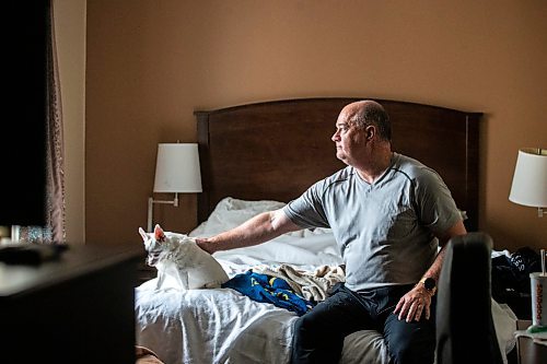 MIKAELA MACKENZIE / FREE PRESS

Des Kappel, displaced resident from Birchwood Terrace, with his dog Nemo in the hotel room they are currently staying in on Wednesday, May 15, 2024. 

For Tyler story.

