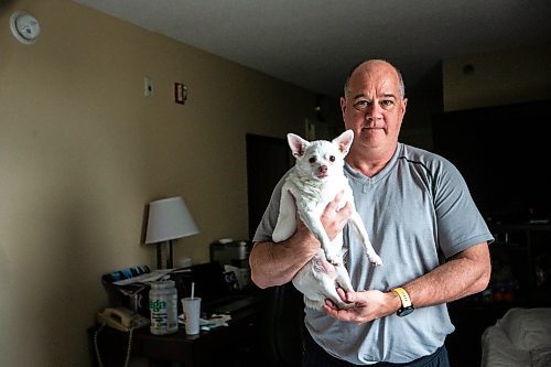 MIKAELA MACKENZIE / FREE PRESS

Des Kappel, displaced resident from Birchwood Terrace, with his dog Nemo in the hotel room they are currently staying in on Wednesday, May 15, 2024. 

For Tyler story.

