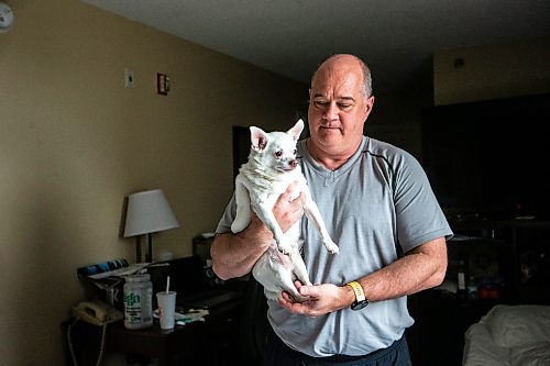 MIKAELA MACKENZIE / FREE PRESS

Des Kappel, displaced resident from Birchwood Terrace, with his dog Nemo in the hotel room they are currently staying in on Wednesday, May 15, 2024. 

For Tyler story.

