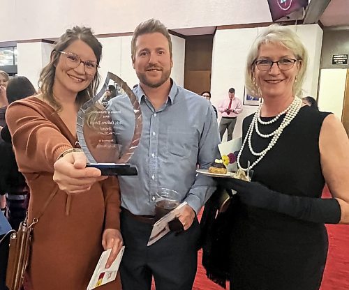 Katy Martin proudly shows off her Women of Distinction award for her contributions to arts, culture and design, Wednesday evening at the Western Manitoba Centennial Auditorium with her husband Brodie Martin and her mother Carmen Jarvis. (Michele McDougall/The Brandon Sun) 
