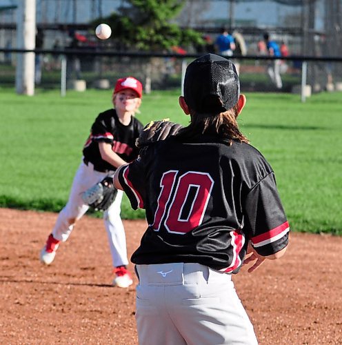 It won't be long before teammates are working in tandem with practices and games, so throwing a runner out at first base will be an easy toss over from second base. (Jules Xavier/The Brandon Sun)