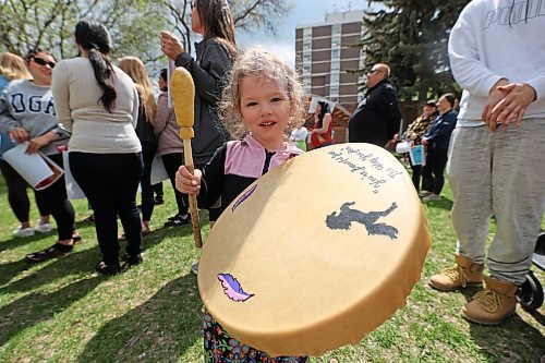 Three-year-old Nevaeh Danielson holds a ceremonial drum at Princess Park, just before the start of the Moose Hide Campaign march along Princess Avenue on Thursday afternoon. She came with her mother, Amy Chegus. See story on Page A4. (Matt Goerzen/The Brandon Sun)