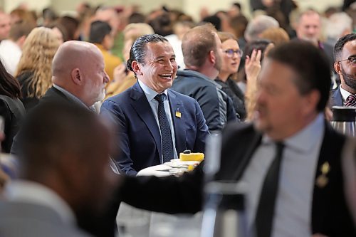 Manitoba Premier Wab Kinew smiles at a joke around the lunch table a few minutes before giving the state of the province speech during a Brandon Chamber of Commerce luncheon on Thursday. (Matt Goerzen/The Brandon Sun)