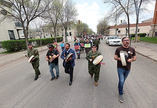 Coun. Kris Desjarlais (Ward 2), who chairs the Brandon Urban Aboriginal Peoples' Council, right, is joined by soldiers from CFB Shilo,  Jason Gobeil from the province's regional cabinet office in Brandon, and Friendship Centre knowledge keeper Frank Tacan as they lead the march down Princess Avenue as part fo the Moose Hide Campaign to end violence against women and children in Canada, Thursday afternoon. (Matt Goerzen/The Brandon Sun)