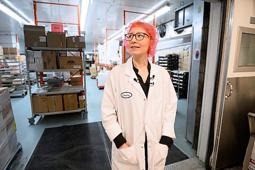 Mike Sudoma/Free Press
WRHA Regional Manager Charity Hanslit stands in front of a large food storage freezer inside of the WRHA Food Distribution Centre Wednesday
May 15, 2024