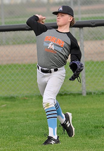 Brayden Olsen is one of 12 players from 21 attending a U13 AAA Marlins tryout to be selected to play this season. Here, he warms his arm up during practice prior to moving to the diamond to work on hitting, running and positional play drills. (Jules Xavier/The Brandon Sun)