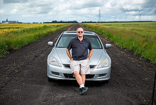 Al Small, Free Press entertainment editor, leans on his trusty road-tripping car just outside of Winnipeg on Saturday, July 18, 2015.   Mikaela MacKenzie / Winnipeg Free Press