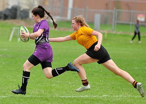 Crocus Plainsmen defender Ocean Kominshin-Glass reaches out to tackle Vincent Massey Vikings wing Maria Matthies, who scored one of her team's four tries. Down 17-5 at the half, Crocus rebounded to win 35-22 after Faith Burtnick ran for five tries. (Jules Xavier/The Brandon Sun)