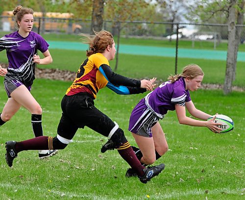 Crocus Plainsmen defender Kaitlyn MacDougall (13) moves in to push Vincent Massey Vikings back Adeline Dunwoody (9) out of bounds during first half action. Soon after, Dunwoody ran in for a try. (Jules Xavier/The Brandon Sun)