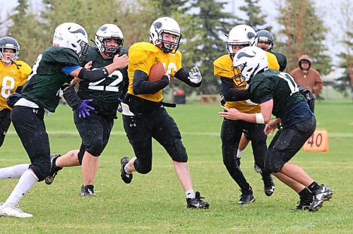 Ticats running back Thomas Seitz (16, gold) cuts into a hole in the middle as Roughriders defenders Logan Jardine (22, dark green) and Ashton Opperman (12, dark green) converge on the ball in Westman Youth Football Association action at Boyd Stadium on a rainy and windy Saturday afternoon. The Ticats earned a 7-0 victory. (Perry Bergson/The Brandon Sun)
May 19, 2024