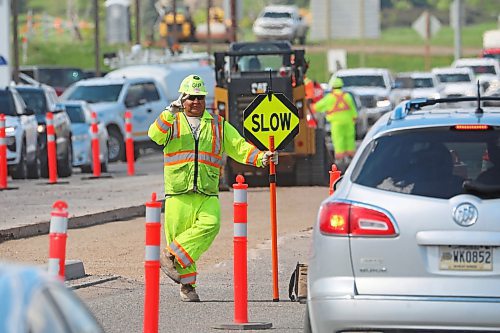 21052024
A road worker waves to commuters as they pass through construction work on 18th Street North in Brandon on Tuesday afternoon. 18th Street has been chosen as the CAA&#x2019;s Worst Road in Manitoba.
(Tim Smith/The Brandon Sun)