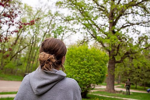 BROOK JONES / FREE PRESS
Sophie Warketine, 22, watches a black bear that climbed up an oak tree at the corner of Manchester Boulevard South and Wildwood Street in Winnipeg's Wildwood neighourhood in Winnipeg, Man., Tuesday, May 21, 2024. Warketine was pictured from her front yard on Manchester Boulevard South.