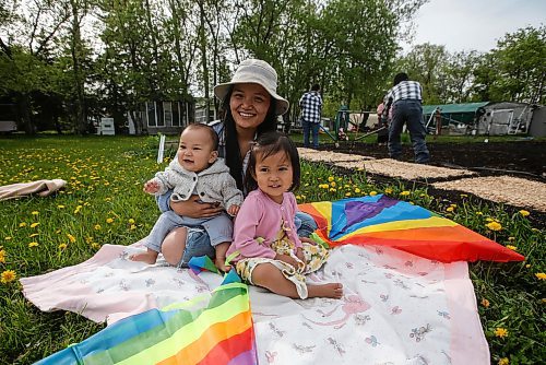 JOHN WOODS / FREE PRESS
ThaMu Eh, plays with her daughters Willow (pink) and Meadow (grey), as her mother Nyo You San, father Doh Htoo Eh and her grand mother work in the garden at their multi-generational home north of Stonewall Tuesday, May 21, 2024. 

Reporter: gabby