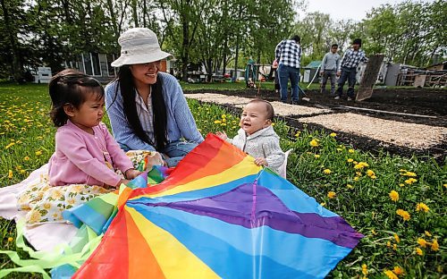 JOHN WOODS / FREE PRESS
ThaMu Eh, plays with her daughters Willow (pink) and Meadow (grey), as her mother Nyo You San, father Doh Htoo Eh, her grand mother and future brother-in-law Ler Pway Htoo work in the garden at their multi-generational home north of Stonewall Tuesday, May 21, 2024. 

Reporter: gabby