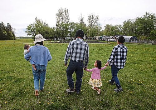 JOHN WOODS / FREE PRESS
ThaMu Eh, left, with her daughters Willow (pink) and Meadow (grey), walk with her father Doh Htoo Eh, centre, and mother Nyo You San at their multi-generational home north of Stonewall Tuesday, May 21, 2024. 

Reporter: gabby