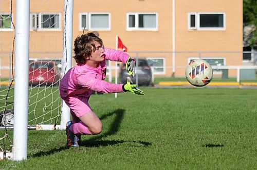 Vincent Massey's Parker Cels dives to save a shot during the penalty shootout. (Thomas Friesen/The Brandon Sun)