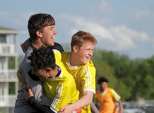 Crocus Plainsmen keeper Parker Bridges, left, ended the seven-round shootout with the winning save before captain Lynden Gould, right, and Ahmed Hamiy rushed to hug him. (Thomas Friesen/The Brandon Sun)