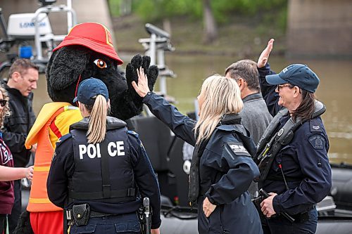 Mike Sudoma/Free Press
Members of the Manitoba RCMP high five Buddy, the mascot for the Life Saving Society of Manitoba prior to a press conference at the Forks Wednesday afternoon
May 22, 2024