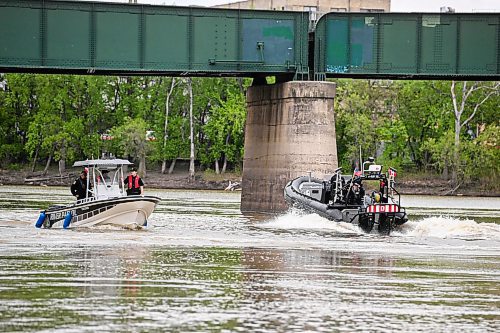 Mike Sudoma/Free Press
RCMP and Winnipeg Police Service River Patrol drive their boats downtown the Assiniboine river as they exit The Forks after a press conference Wednesday
May 22, 2024