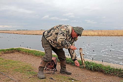 Ketcheson releases a northern pike while fishing at the lake’s outlet dam. (Tim Smith/The Brandon Sun)