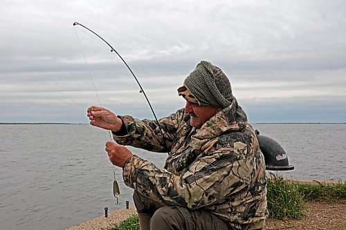 23052024
Mike Ketcheson of Brandon fishes at Oak Lake on a windy Thursday afternoon. Ketcheson tries to get out fishing throughout western Manitoba every few days, year round and spent Thursday catching northern pike and pickerel. 
(Tim Smith/The Brandon Sun)