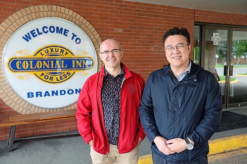 Supervising manager Alexey Volosnikov and co-owner Leo Ho outside the Colonial Inn, recently purchased by Ho, on Thursday. (Tim Smith/The Brandon Sun)