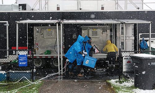 Snow falls as workers with the Western Canada Rib Fest Tour ready for the supper rush after the inclement weather delayed the start of the event's opening day on Friday. (Matt Goerzen/The Brandon Sun)