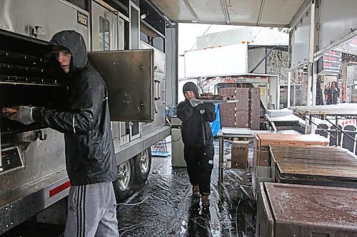 Staff with Blazin BBQ stack a platters of ribs from the smoker in preparation for Friday evening's dinner rush, after a day of snowy May weather postponed the opening of the Western Canada Rib Fest Tour at Brandon's Riverbank Discovery Centre on the first day of the event. (Matt Goerzen/The Brandon Sun)