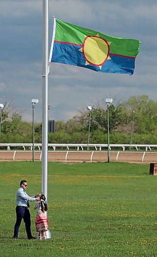 JASON HALSTEAD / FREE PRESS
Vic Savino, Treaty 1 Nations director of communications, and his daughter Tahliah Savino, 9, take part in the raising of the Treaty 1 Nations flag on the Assiniboia Downs racetrack grounds as part of opening day ceremonies for the 2024 thoroughbred horse-racing season on May 20, 2024.