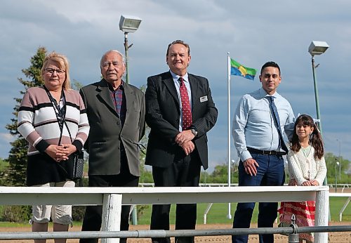 JASON HALSTEAD / FREE PRESS
Peguis First Nation councillor Linda Sinclair (from left), Treaty 1 knowledge keeper Jim Sinclair, Vic Savino, Treaty 1 Nations director of communications, and his daughter Tahliah Savino, 9, take part in the raising of the Treaty 1 Nations flag on the Assiniboia Downs racetrack grounds as part of opening day ceremonies for the 2024 thoroughbred horse-racing season on May 20, 2024.