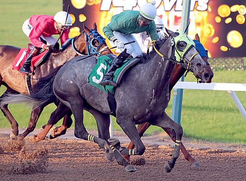 JASON HALSTEAD / FREE PRESS
Jockey Prayven Badrie rides Prayforpeace to victory in Race 2 on the opening day of live thoroughbred racing on May 20, 2024 at Assiniboia Downs.