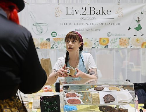 Olivia Thompson, creator of Liv2Bake makes a sale of one of her gluten-free and celiac-friendly products to a customer Saturday afternoon at the Apple and Pine Market held in the Manitoba Room at the Keystone Centre. (Michele McDougall/The Brandon Sun)
