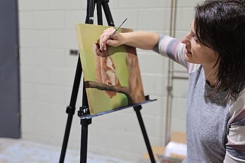 Neepawa artist Stephanie Bretecher works with acrylics and watercolours and paints while she makes sales at her booth during the Apple and Pine Market held in the Manitoba Room at the Keystone Centre on Saturday. (Michele McDougall/The Brandon Sun)

