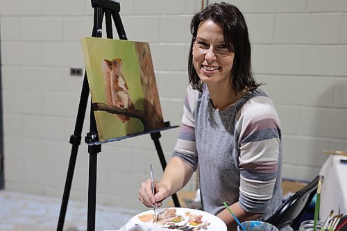 Neepawa artist Stephanie Bretecher works with acrylics and watercolours and paints while she makes sales at her booth during the Apple and Pine Market held in the Manitoba Room at the Keystone Centre on Saturday. (Michele McDougall/The Brandon Sun)