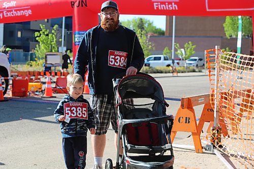 Michael Andrew and his 3-year-old son Oliver walked and rolled the 5K loop during the 45th annual YMCA Strong Kids Run on Sunday that started and ended in downtown Brandon. (Michele McDougall/The Brandon Sun)  