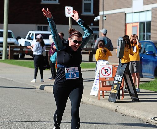 A runner celebrates as she nears the finish line during the 45th annual YMCA Strong Kids Run on Sunday that started and ended in downtown Brandon. (Michele McDougall/The Brandon Sun)  