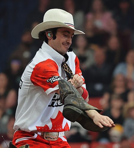 Entertainer Brinson Harris puts his hand through a pair of boots as he looked for the worst pair in the crowd so he could give away some new ones during  the PBR Chute Out at Westman Place on Saturday evening in front of an enthusiastic sold-out crowd. (Perry Bergson/The Brandon Sun)
May 25, 2024