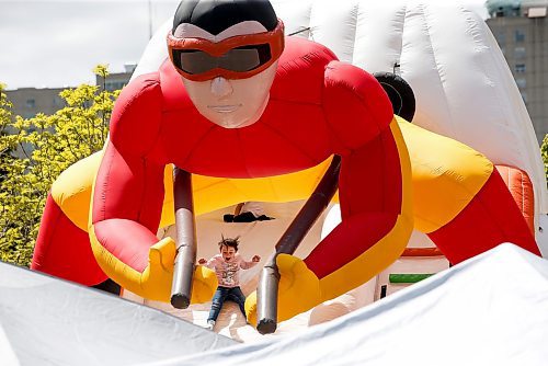 JOHN WOODS / FREE PRESS
A child slides down an inflatable slide during Taste of Asia at the Forks Sunday, May 26, 2024. 

Reporter: standup