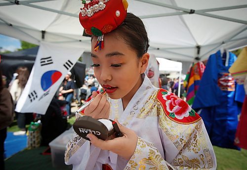 JOHN WOODS / FREE PRESS
Yugyeong Kim, a performer with Red Lotus Korean dance group, gets ready for her performance during Taste of Asia at the Forks Sunday, May 26, 2024. 

Reporter: standup