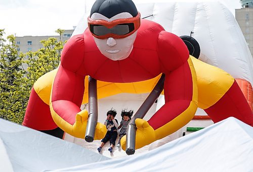 JOHN WOODS / FREE PRESS
Children slide down an inflatable slide during Taste of Asia at the Forks Sunday, May 26, 2024. 

Reporter: standup